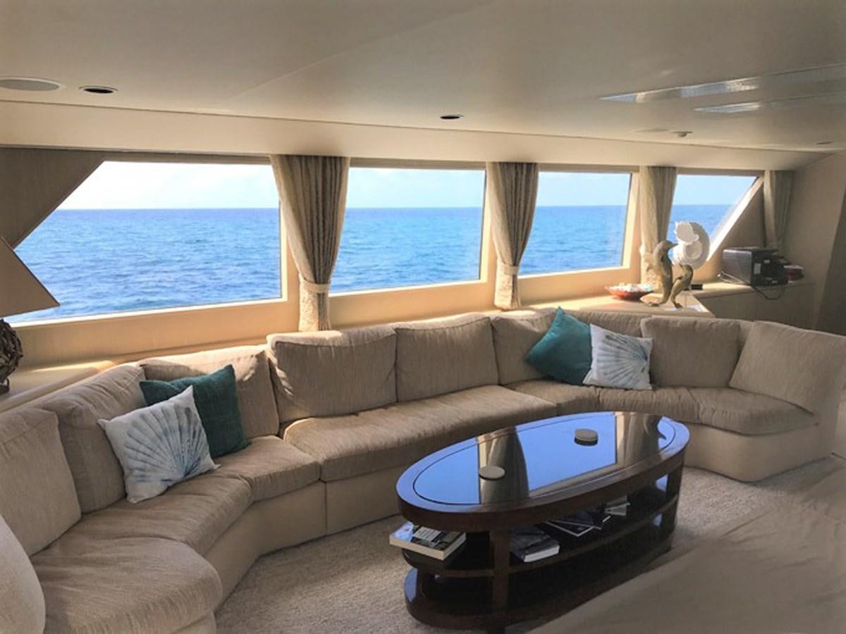 a living room with a couch and a table aboard MON SHERI Yacht for Sale