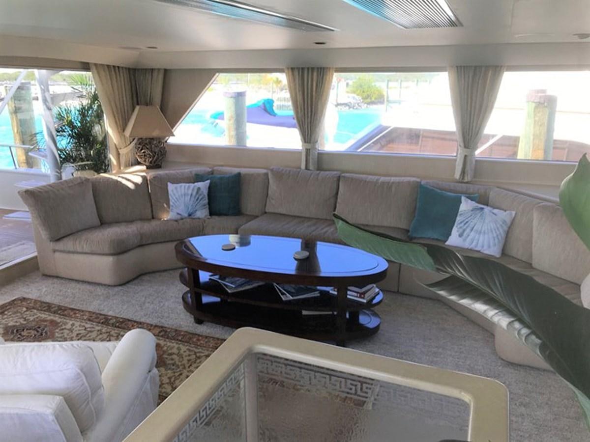 a living room with a couch and a table aboard MON SHERI Yacht for Sale