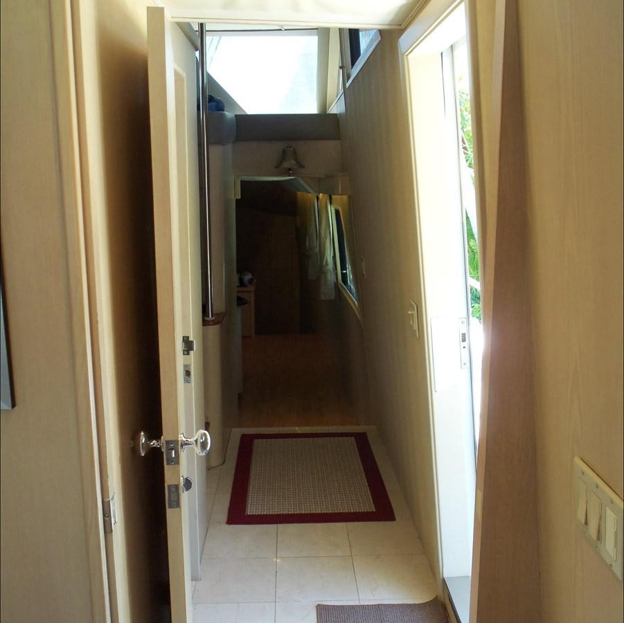 a hallway with a door and a rug on the floor aboard MON SHERI Yacht for Sale