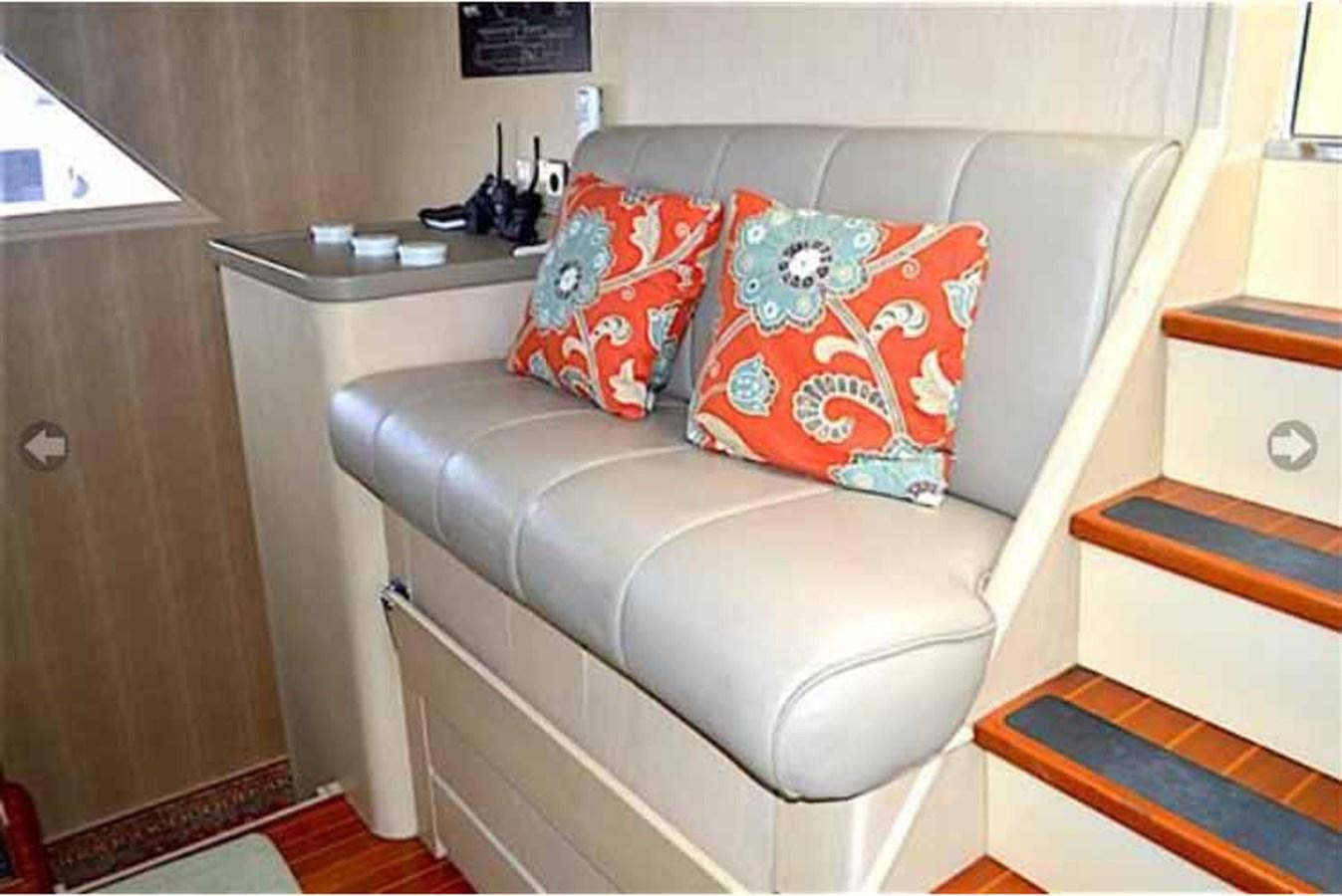 a couch with a pillow on it aboard MON SHERI Yacht for Sale