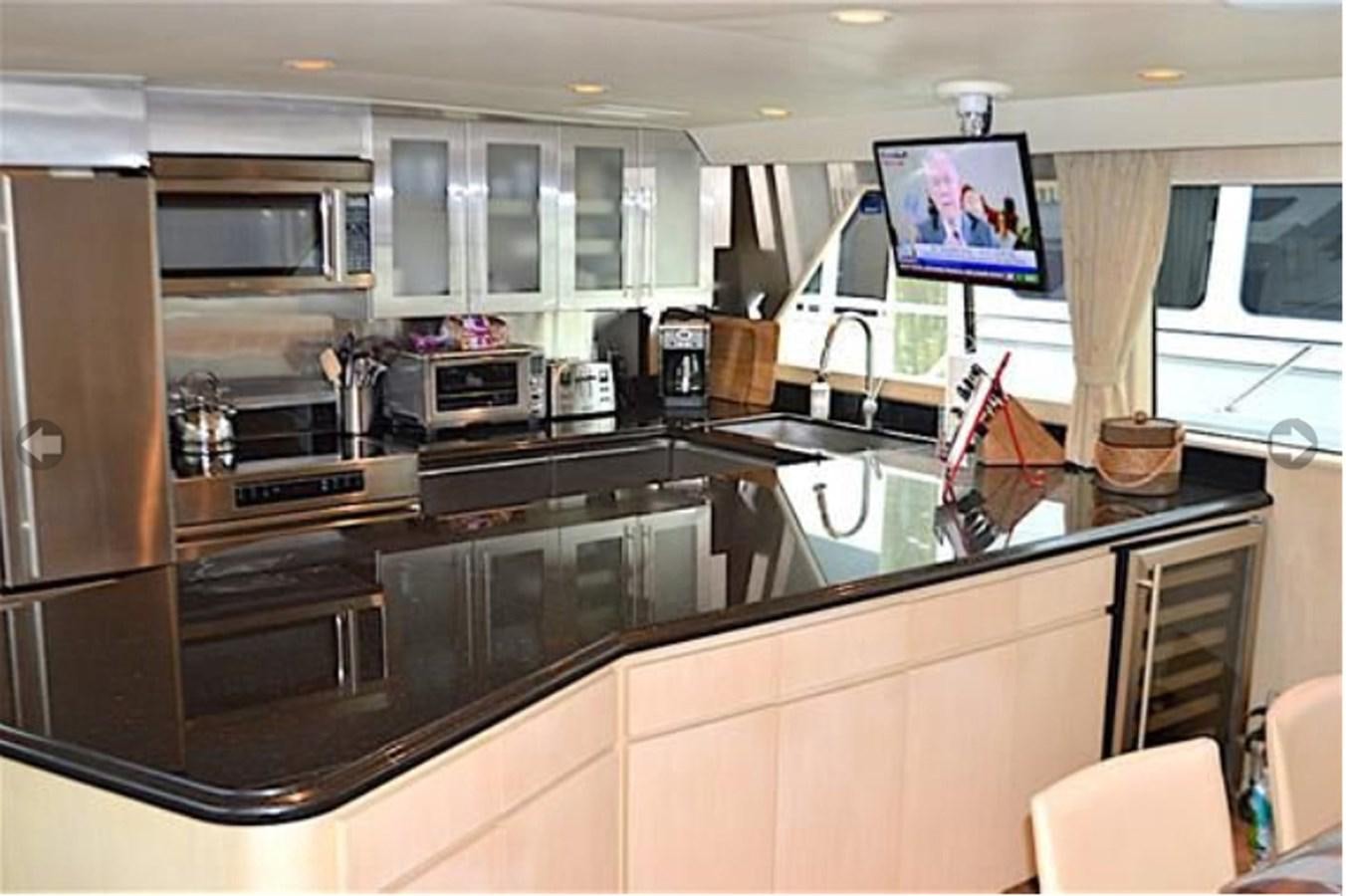 a kitchen with a large island aboard MON SHERI Yacht for Sale