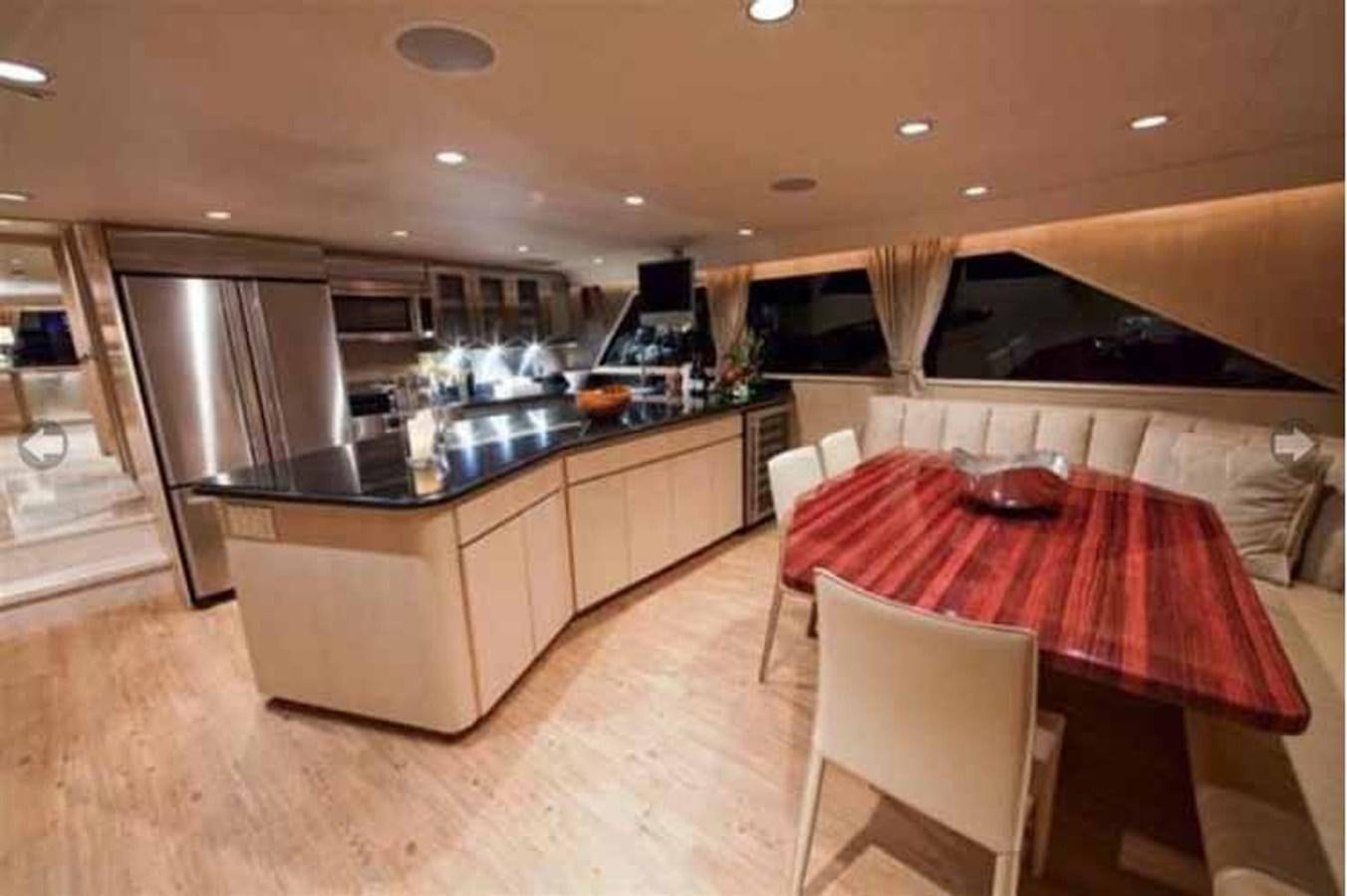 a kitchen with a table and chairs aboard MON SHERI Yacht for Sale