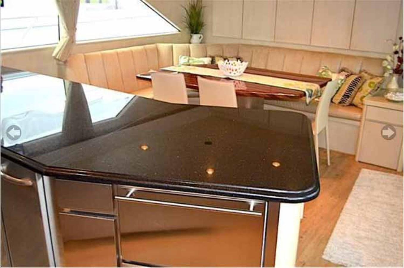 a kitchen with a large island aboard MON SHERI Yacht for Sale