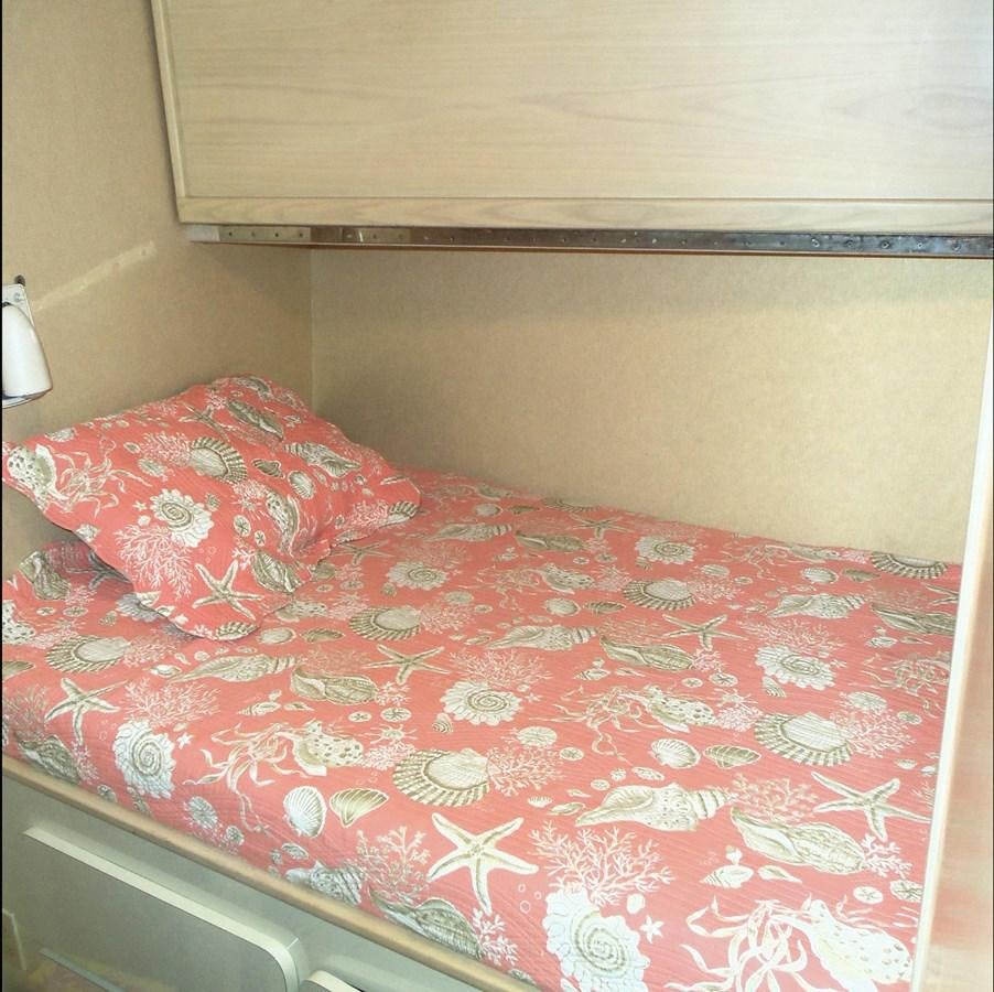 a bed with a pink comforter aboard MON SHERI Yacht for Sale