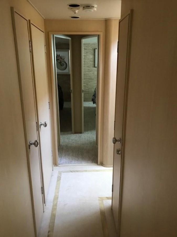 a hallway with a door and ceiling fan aboard MON SHERI Yacht for Sale