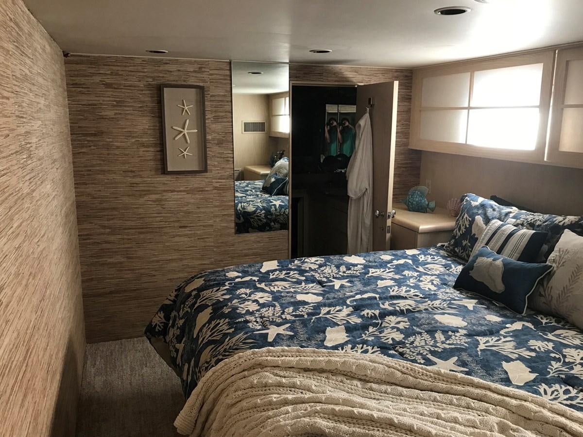 a bedroom with a bed aboard MON SHERI Yacht for Sale