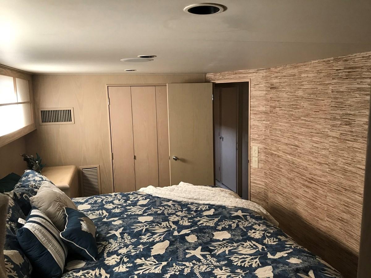 a bedroom with a bed and a door aboard MON SHERI Yacht for Sale