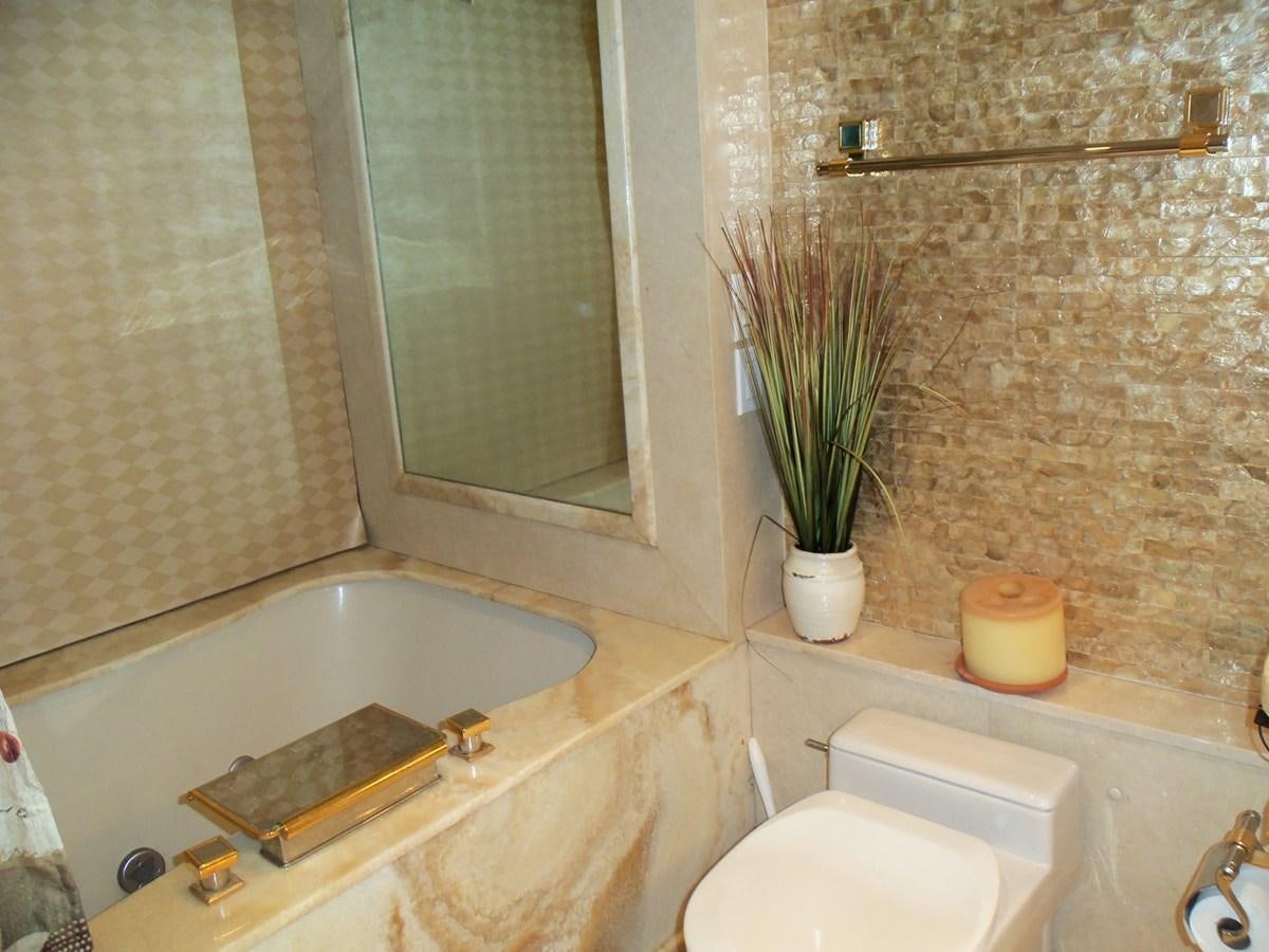 a bathroom with a tub sink and toilet aboard MON SHERI Yacht for Sale