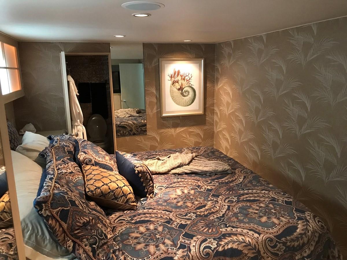 a bedroom with a bed and a mirror aboard MON SHERI Yacht for Sale