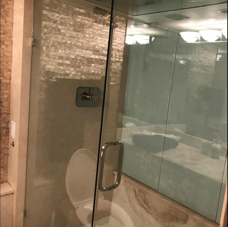 a bathroom with a glass door aboard MON SHERI Yacht for Sale