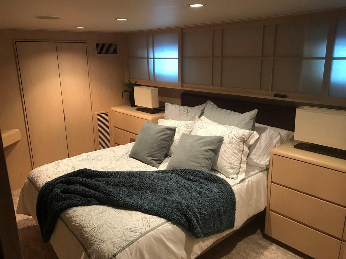 a bed with a blue blanket aboard MON SHERI Yacht for Sale