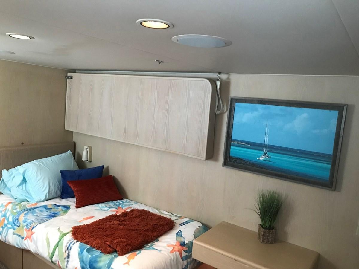 a bedroom with a bed and a tv aboard MON SHERI Yacht for Sale
