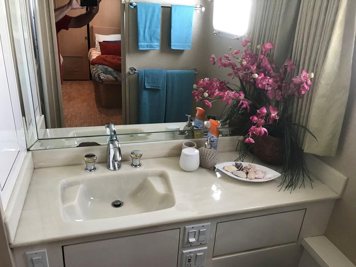 a bathroom with a sink and mirror aboard MON SHERI Yacht for Sale