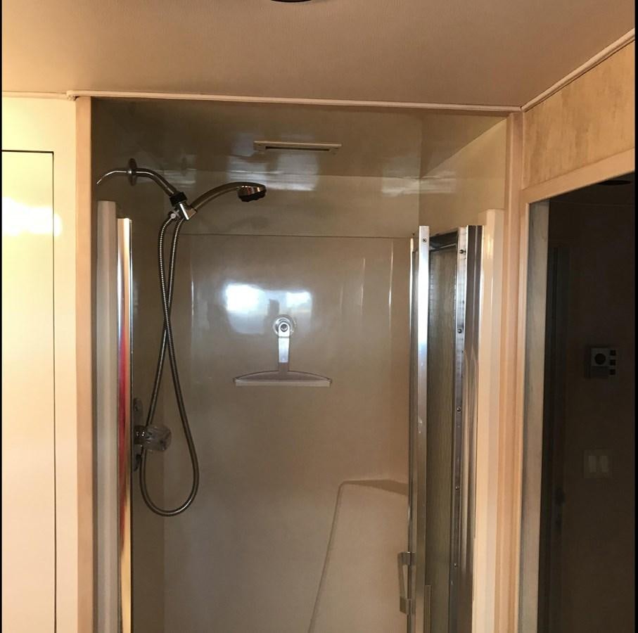a shower with a light on the wall aboard MON SHERI Yacht for Sale