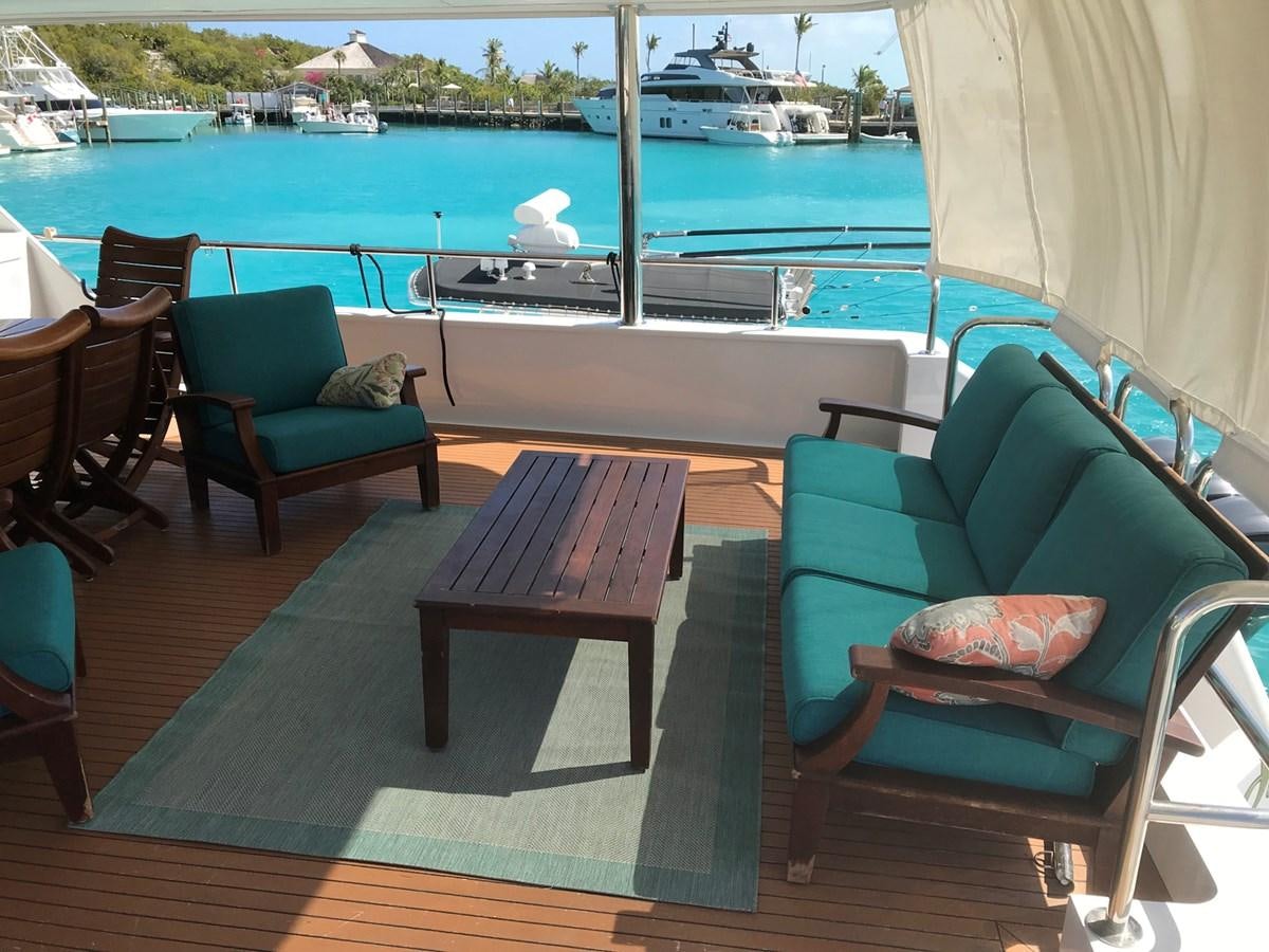 a table and chairs on a deck aboard MON SHERI Yacht for Sale