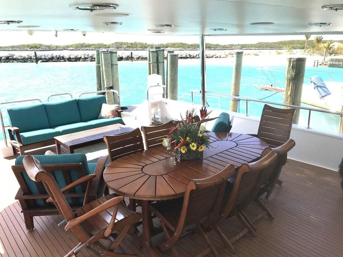a table and chairs on a deck aboard MON SHERI Yacht for Sale