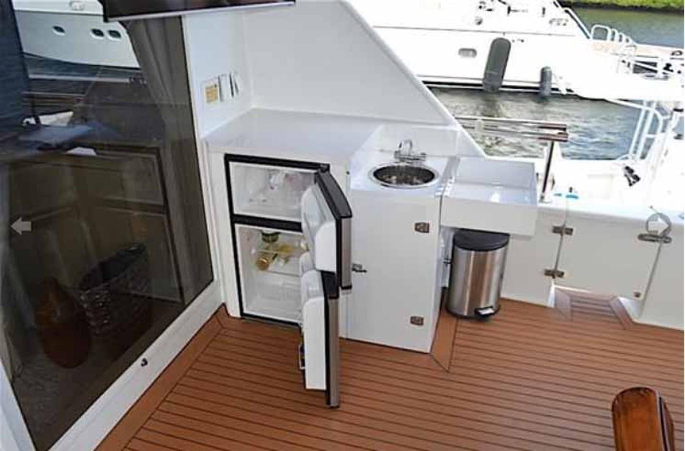 a kitchen with a wood floor aboard MON SHERI Yacht for Sale