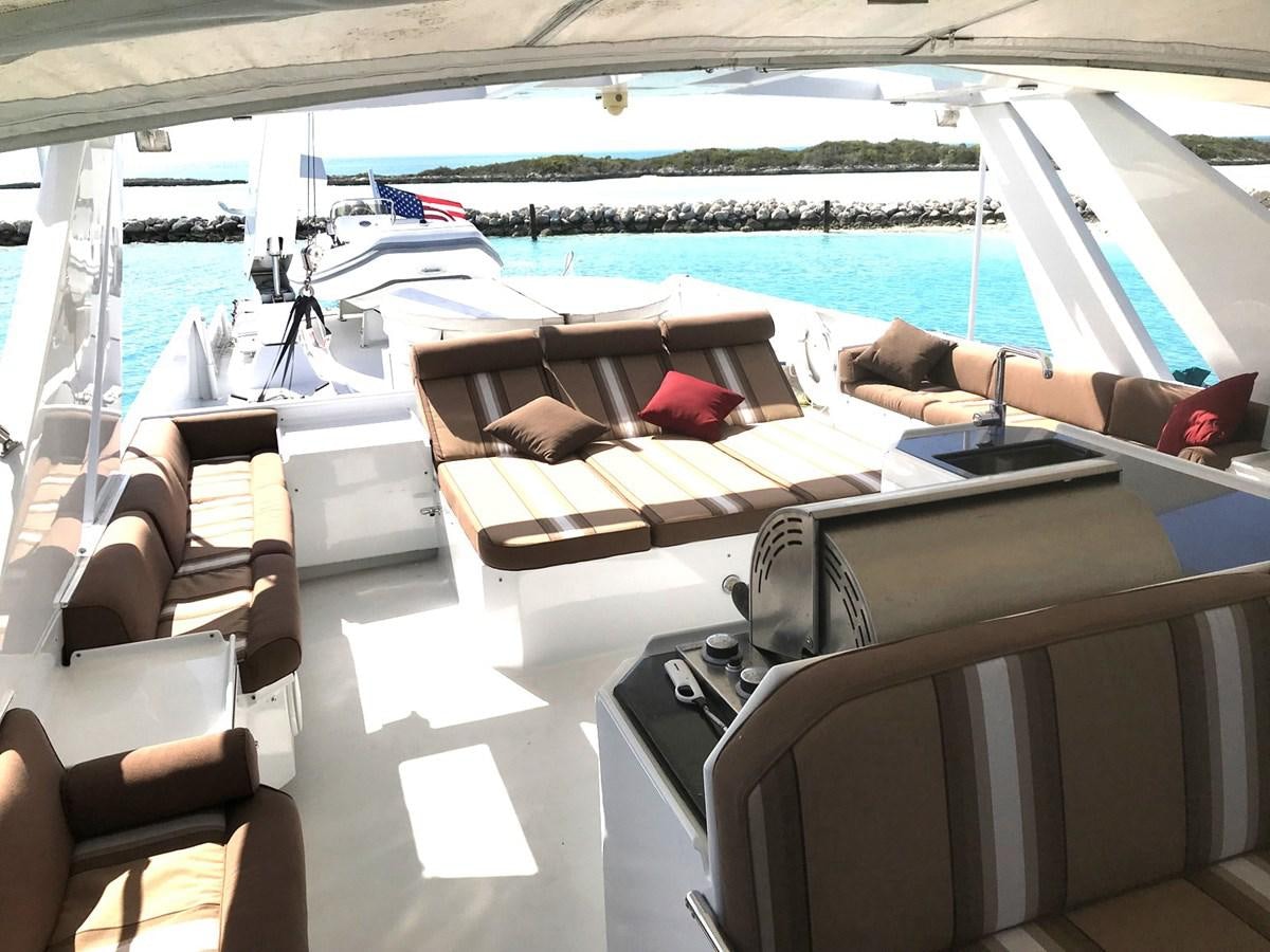 a boat with chairs and tables aboard MON SHERI Yacht for Sale