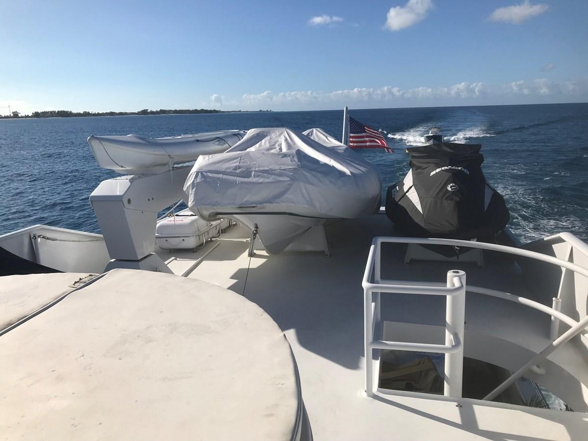 a boat with a flag on it aboard MON SHERI Yacht for Sale