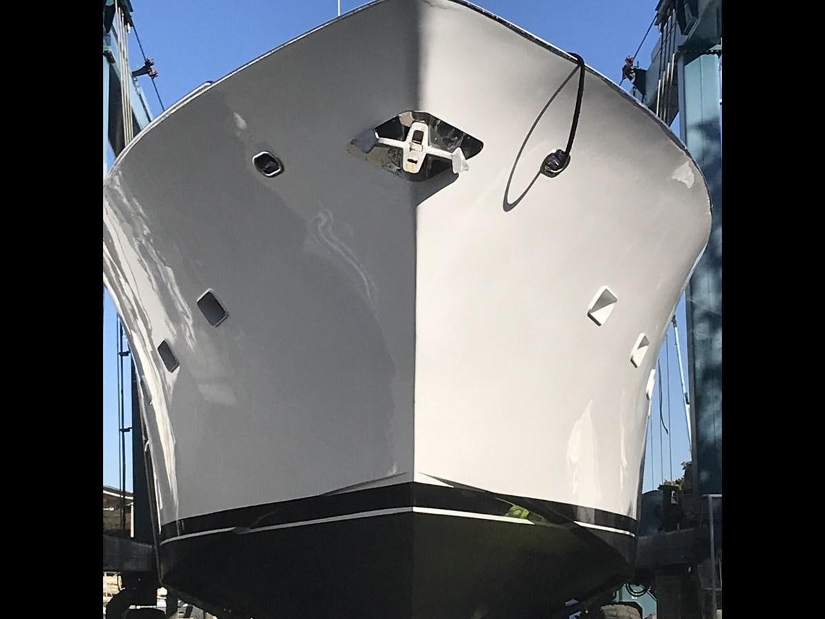 a white boat in a harbor aboard MON SHERI Yacht for Sale