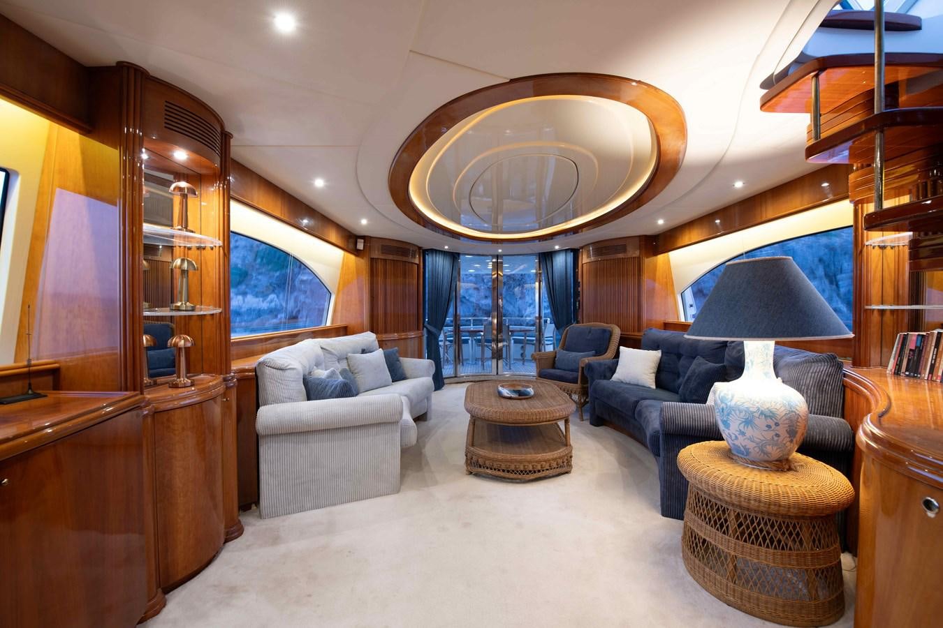 a living room with a large mirror aboard STOLI Yacht for Sale