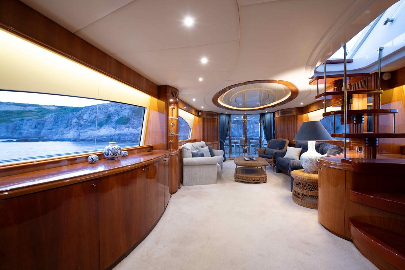 a large living room with a large window aboard STOLI Yacht for Sale