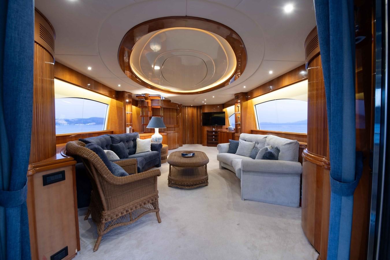 a living room with a large mirror aboard STOLI Yacht for Sale