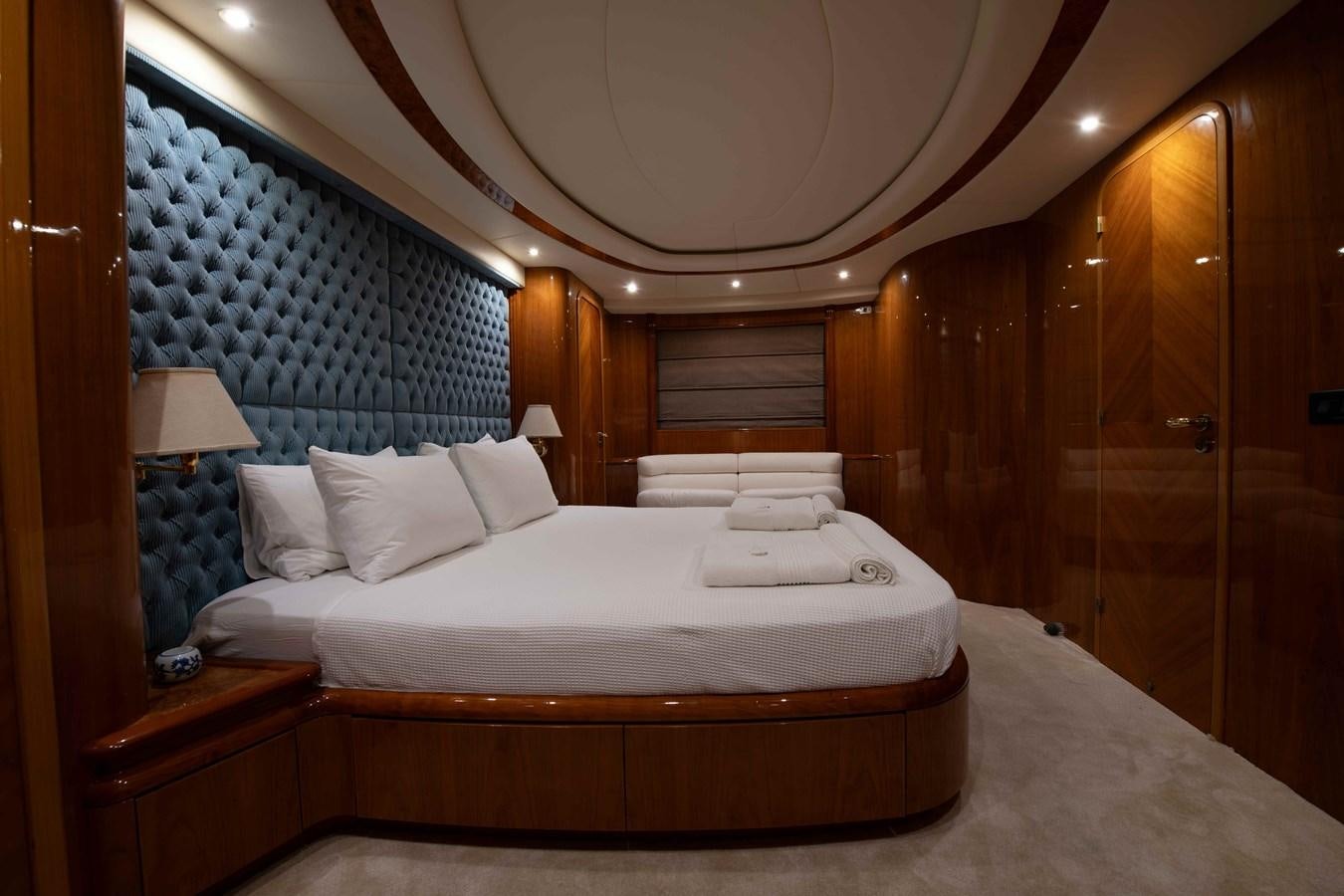 a bed with white sheets aboard STOLI Yacht for Sale
