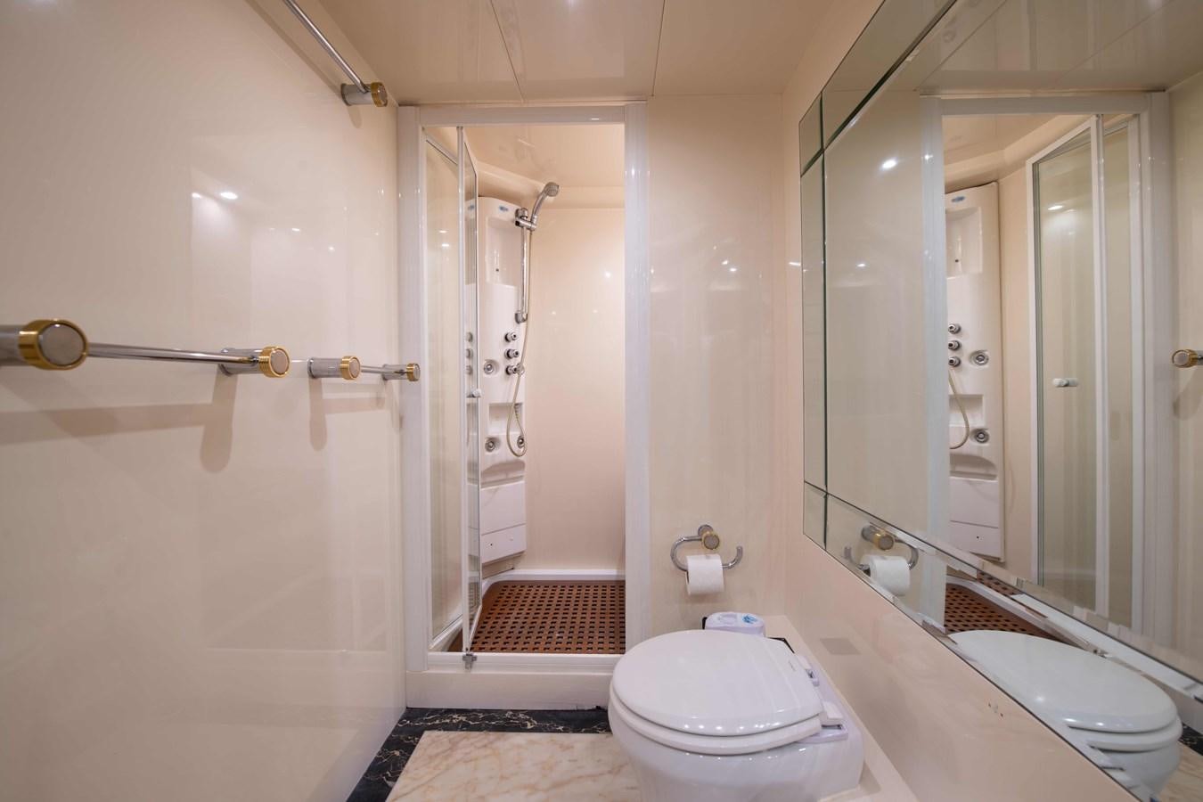 a bathroom with a glass shower aboard STOLI Yacht for Sale