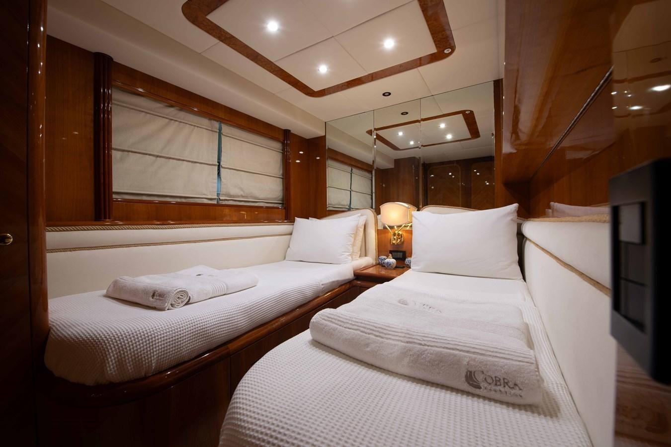 a room with two beds aboard STOLI Yacht for Sale