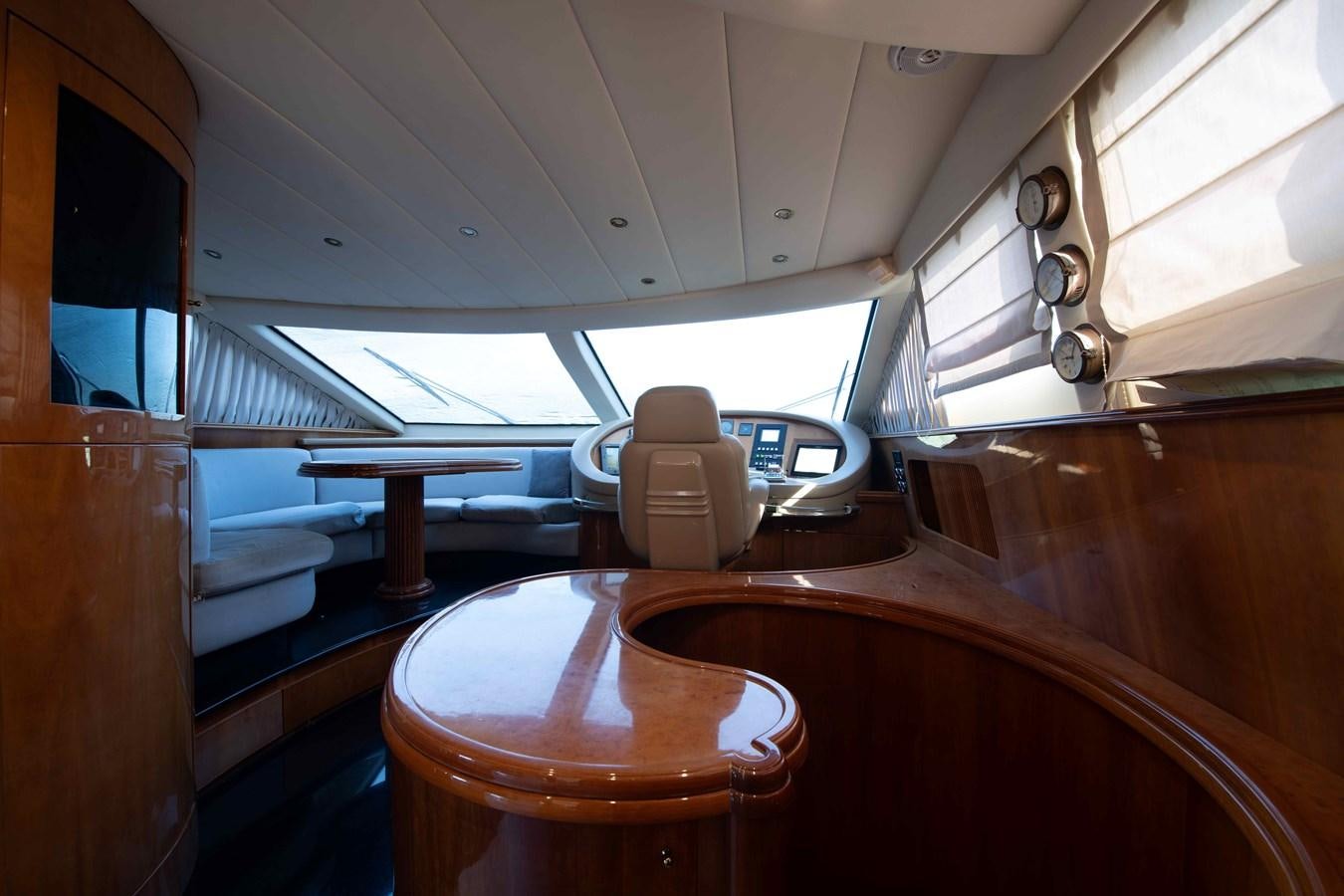 a wooden table with a white chair aboard STOLI Yacht for Sale