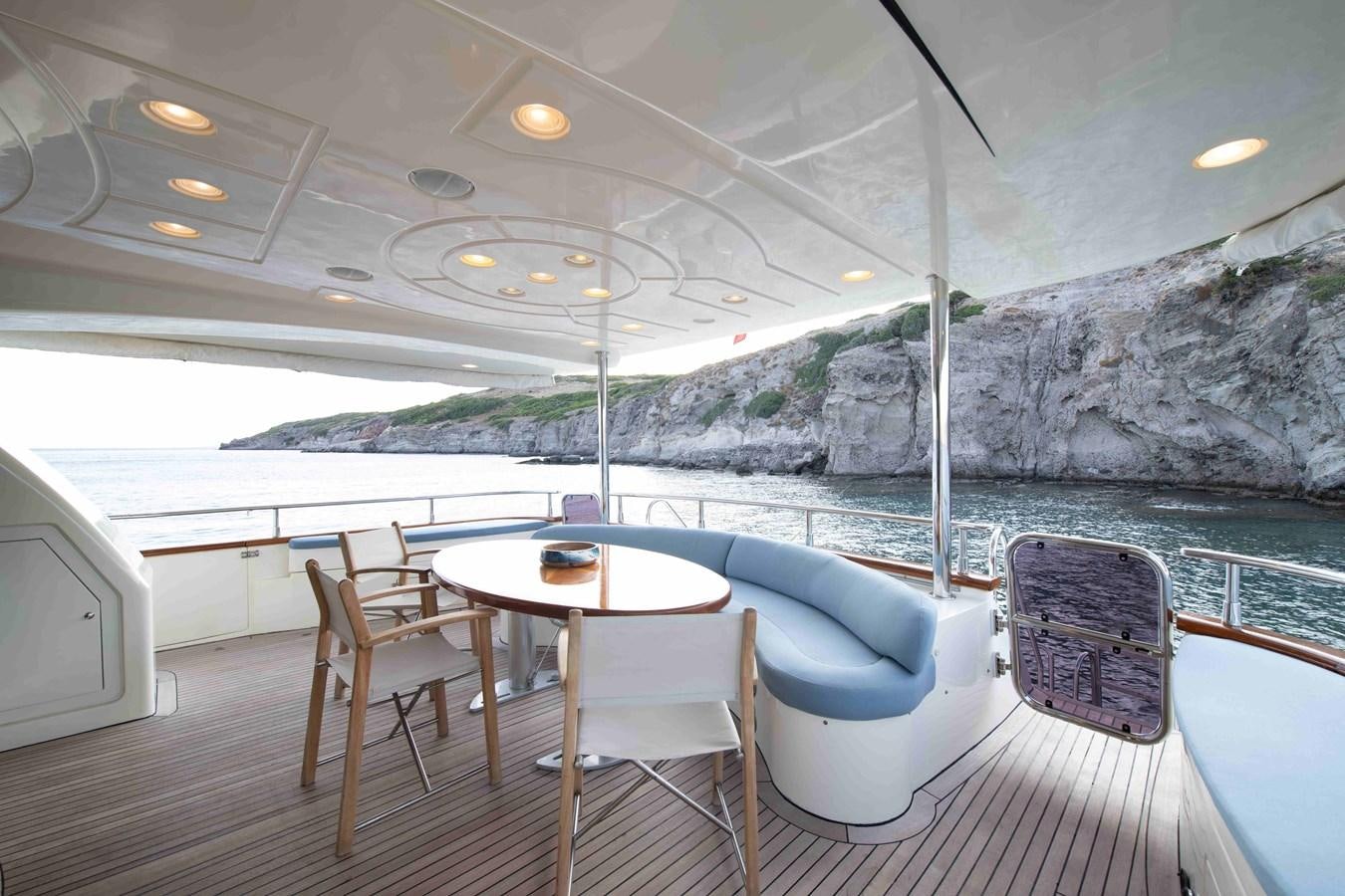 a table and chairs on a boat aboard STOLI Yacht for Sale