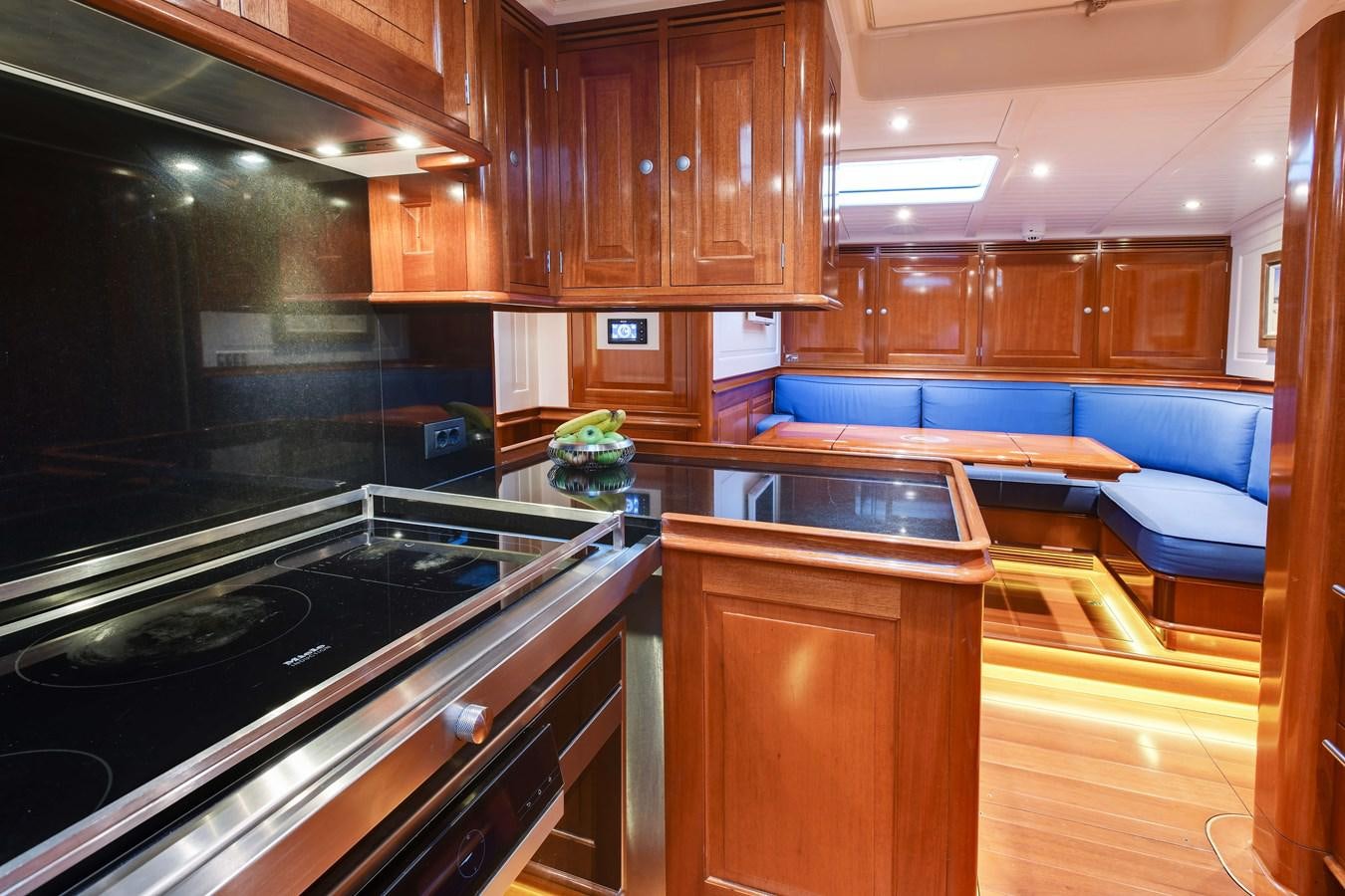 a kitchen with wooden cabinets aboard ATALANTE Yacht for Sale