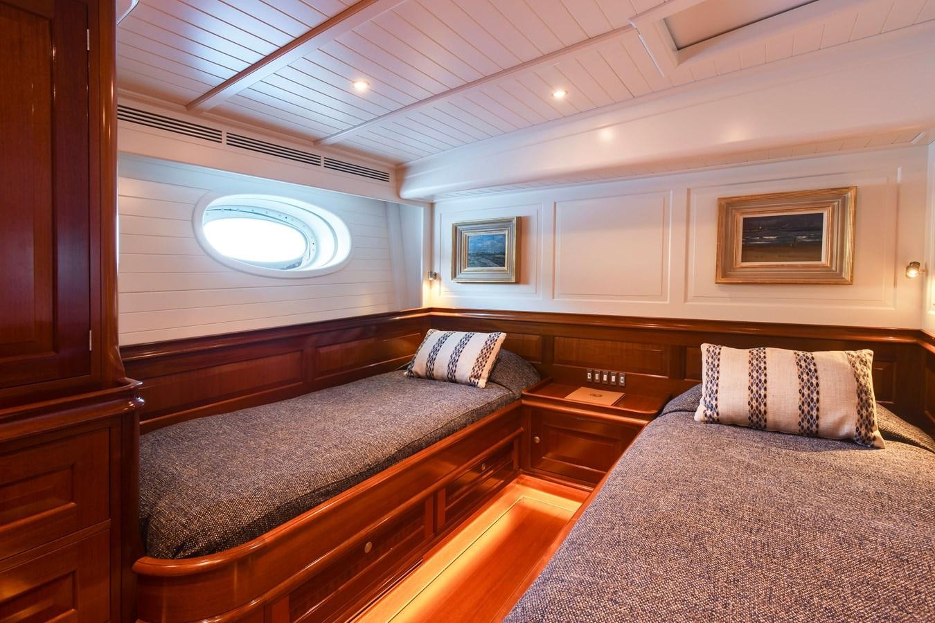 a bedroom with a bed and a large mirror aboard ATALANTE Yacht for Sale