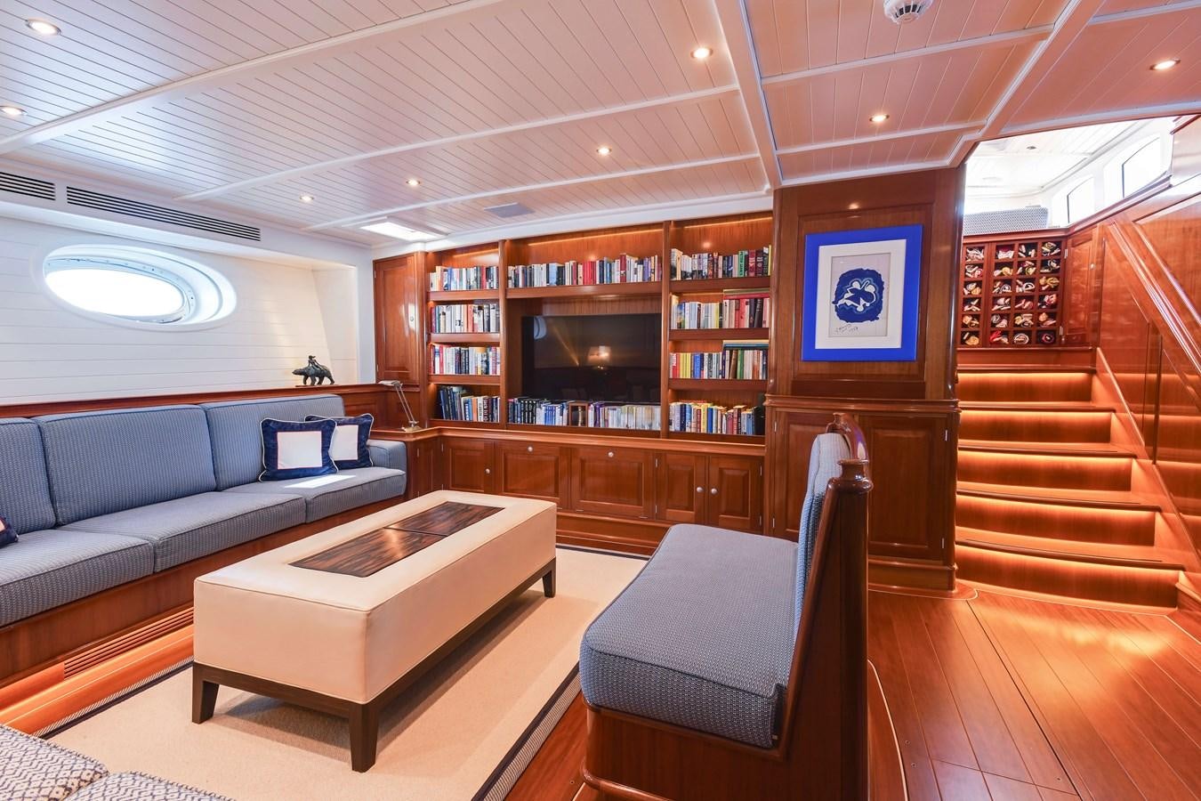 a room with a couch and a table and a tv aboard ATALANTE Yacht for Sale