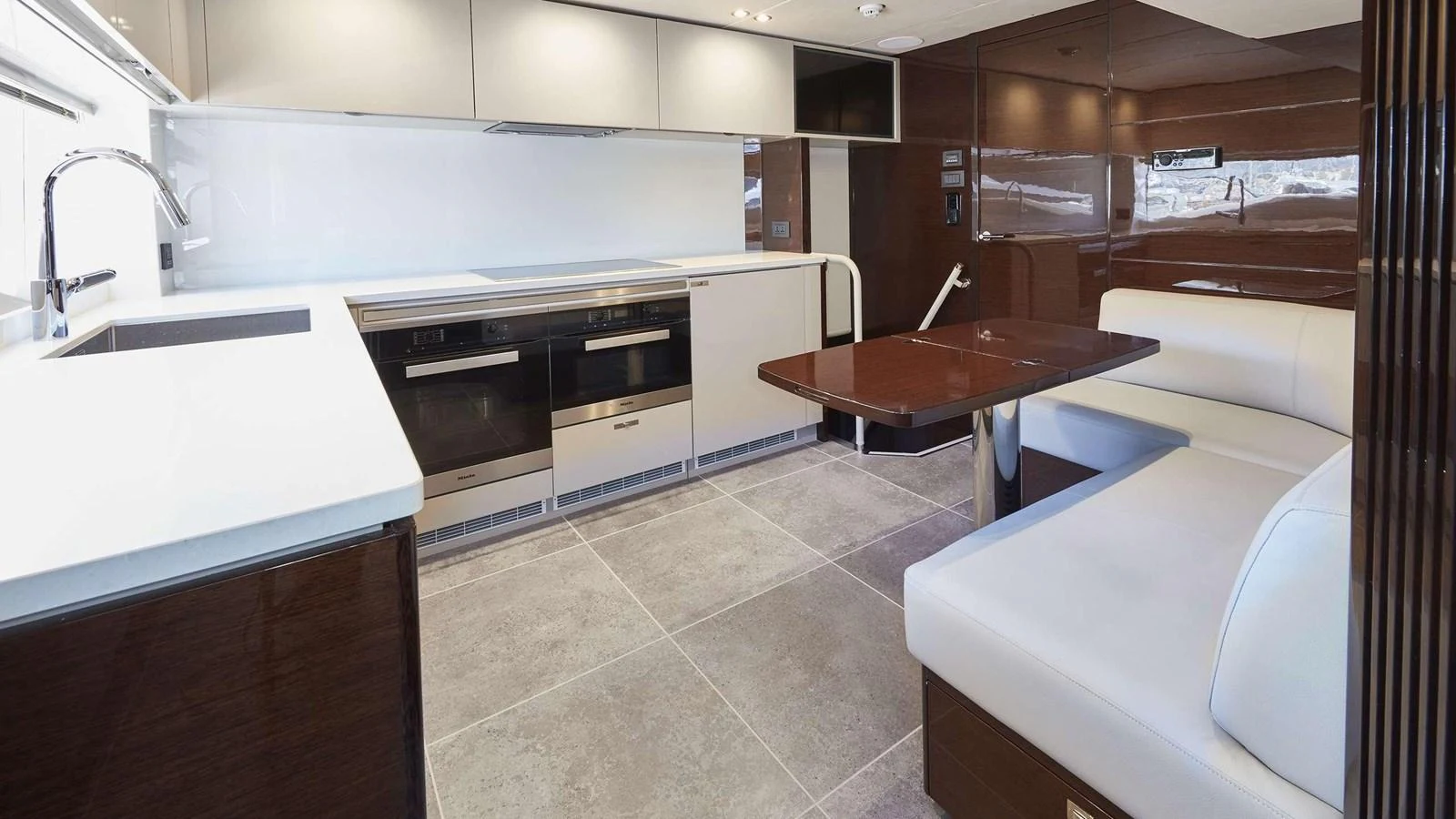 a kitchen with a countertop sink and a stove aboard GHOST Yacht for Sale