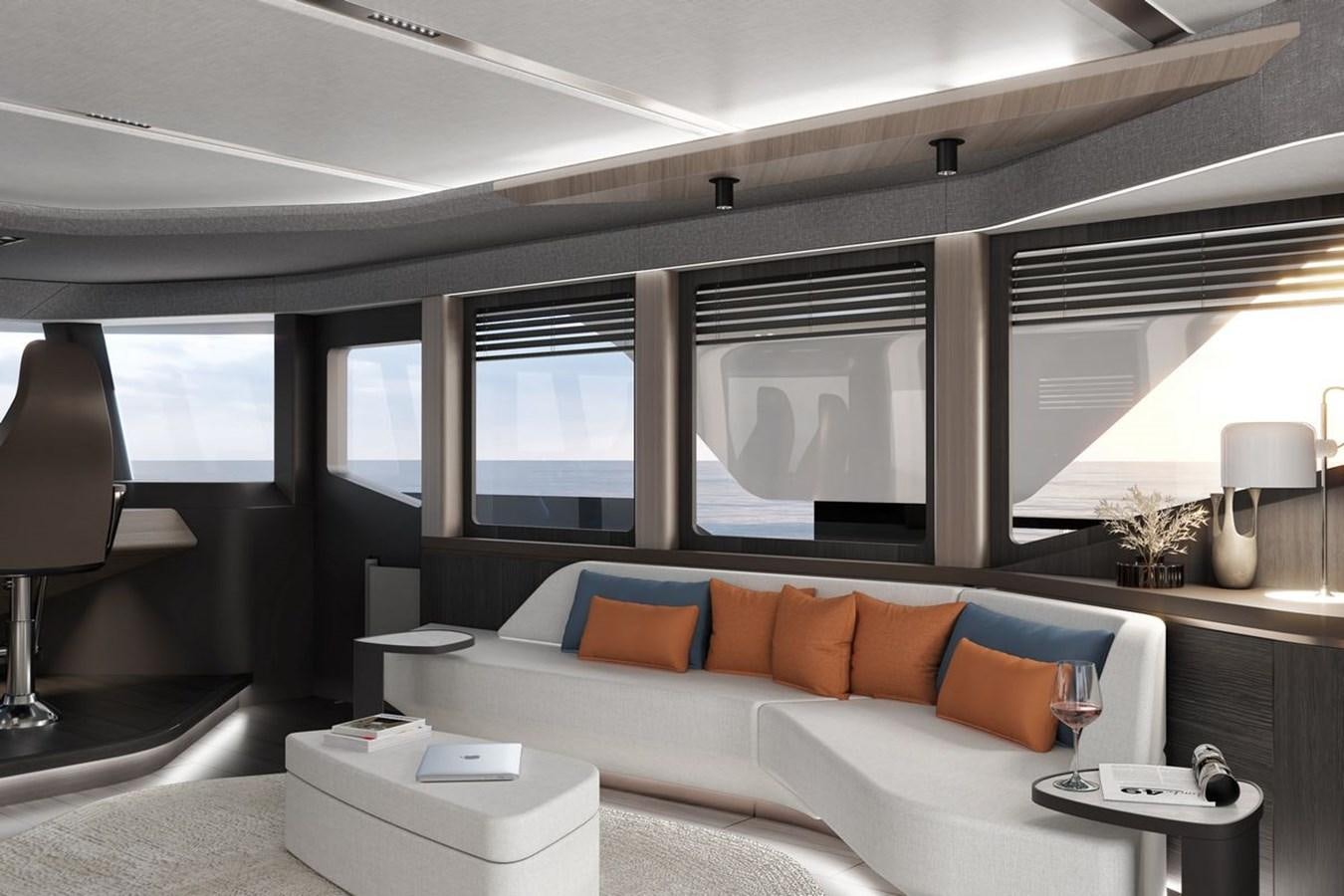 a white couch in a room aboard KANDO 85 Yacht for Sale