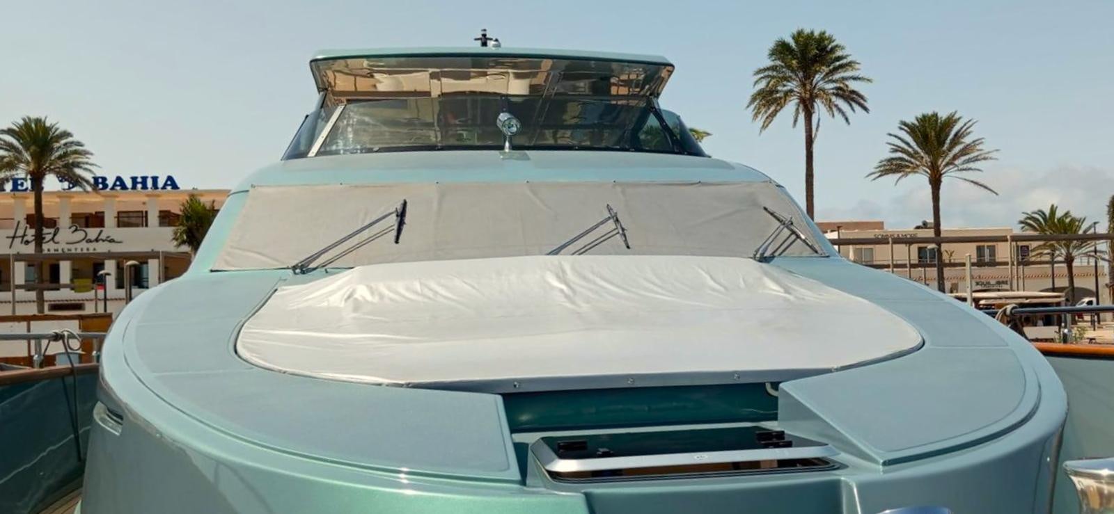 a white boat on a beach aboard UNICA Yacht for Sale