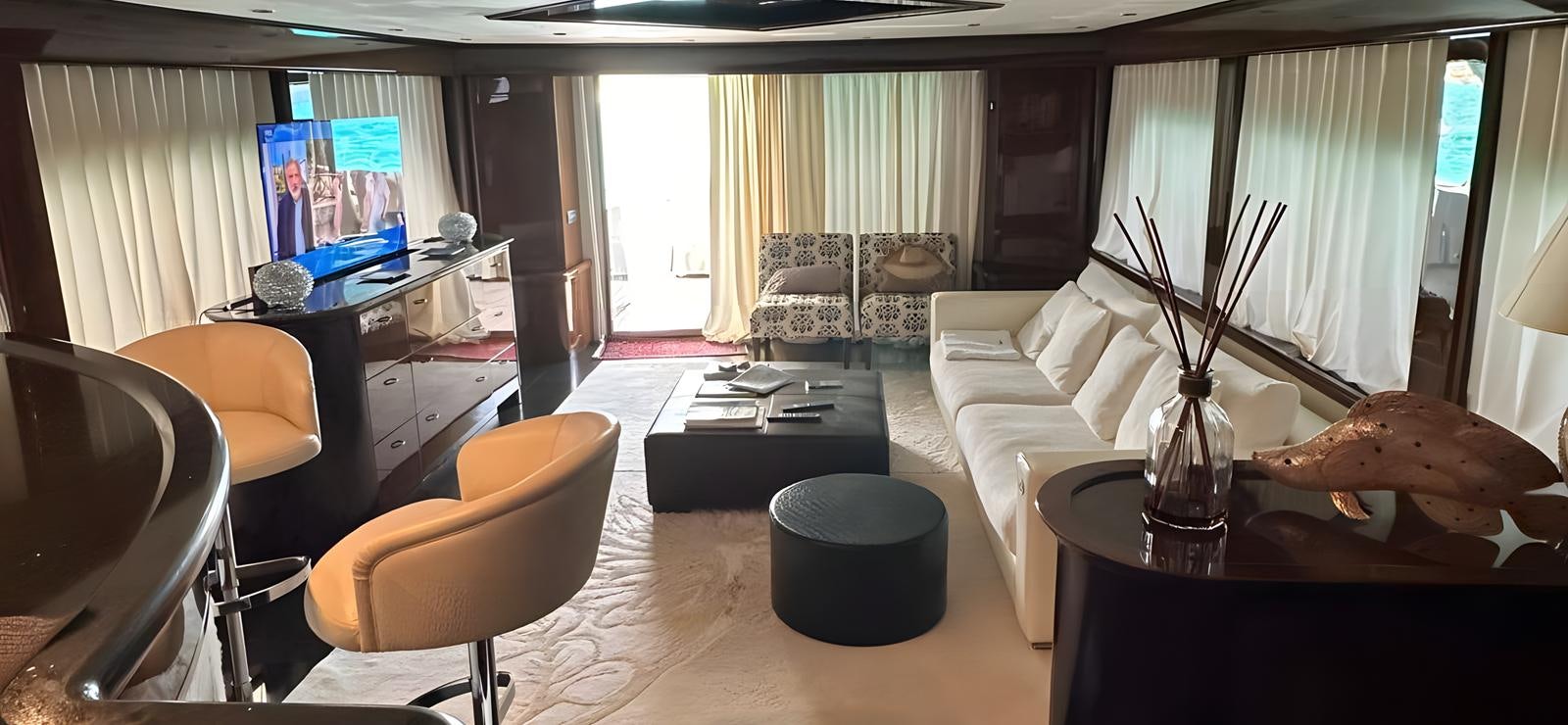 a living room with a desk and chairs aboard UNICA Yacht for Sale