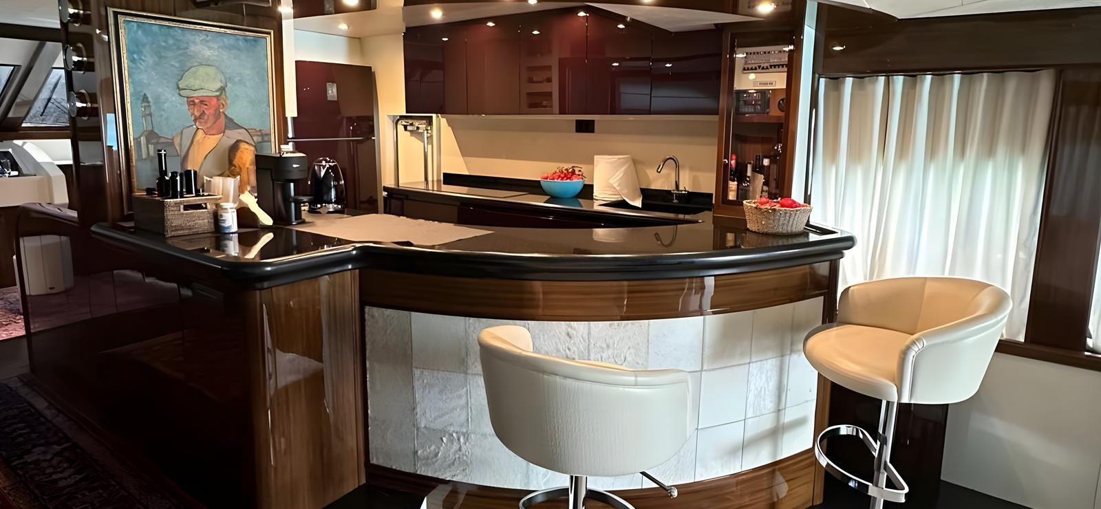 a kitchen with a table and chairs aboard UNICA Yacht for Sale