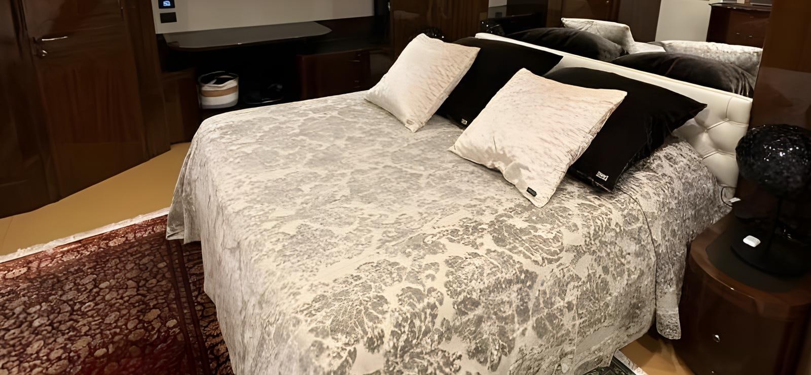 a bed with white sheets aboard UNICA Yacht for Sale