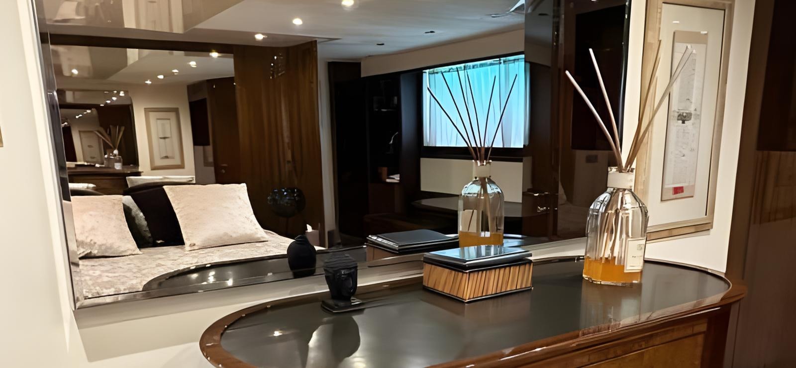 a room with a bed and a glass of beer aboard UNICA Yacht for Sale