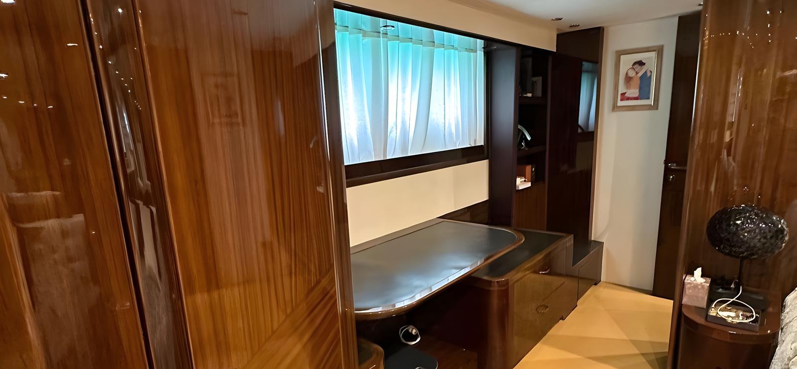 a room with a table and a window aboard UNICA Yacht for Sale