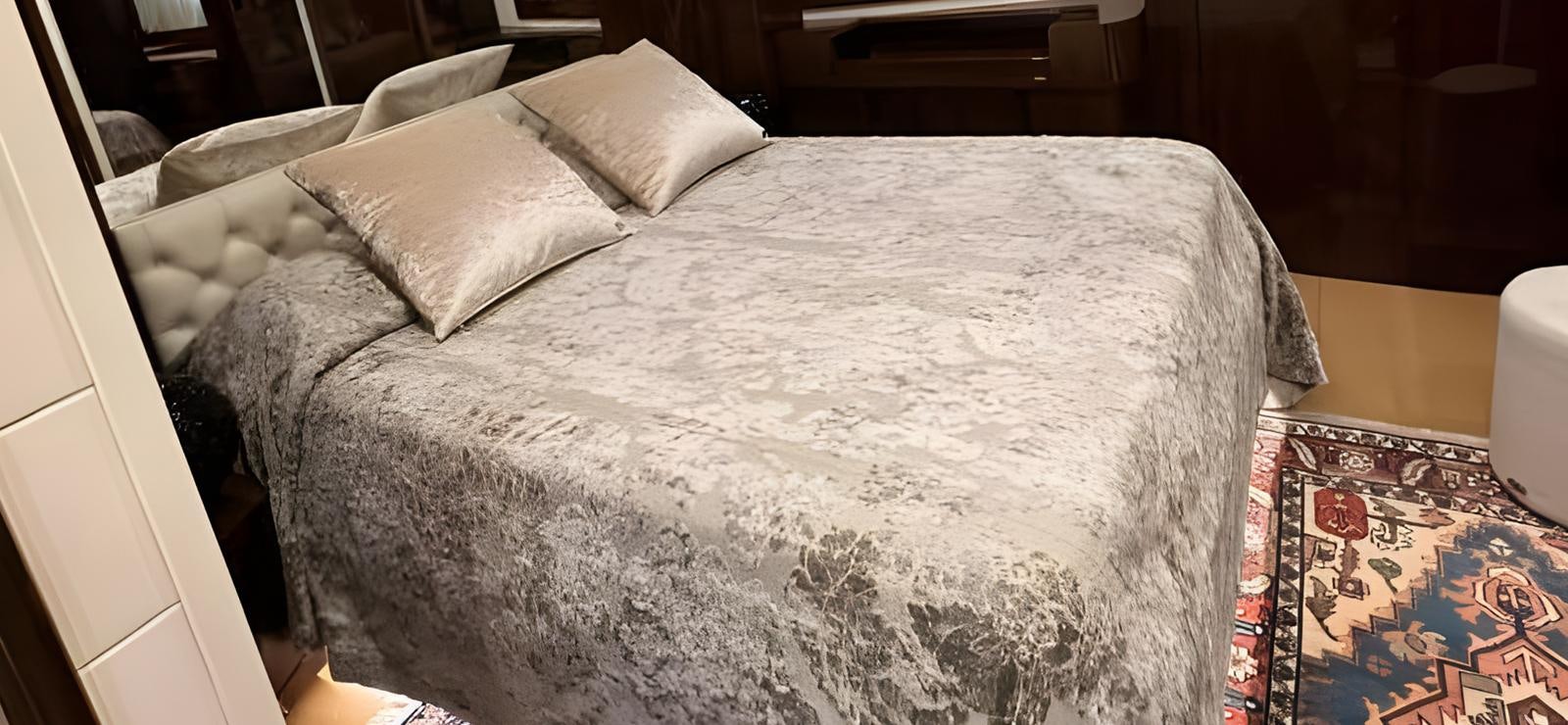 a bed with white sheets aboard UNICA Yacht for Sale