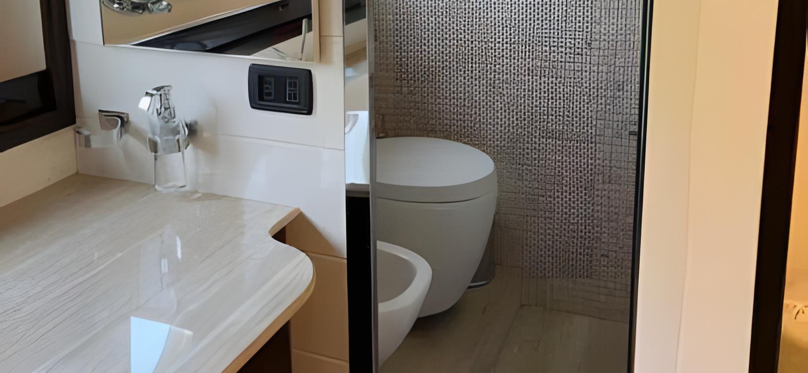 a bathroom with a toilet and sink aboard UNICA Yacht for Sale