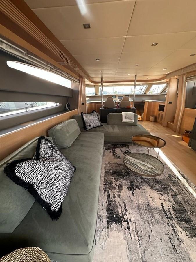 a living room with a couch and a coffee table aboard PATHOS Yacht for Sale
