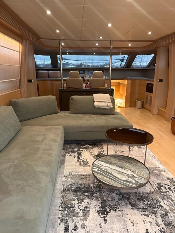 a living room with a couch and a table aboard PATHOS Yacht for Sale
