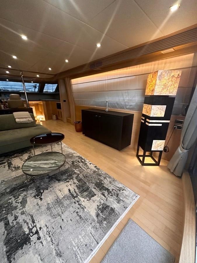a living room with a fireplace aboard PATHOS Yacht for Sale