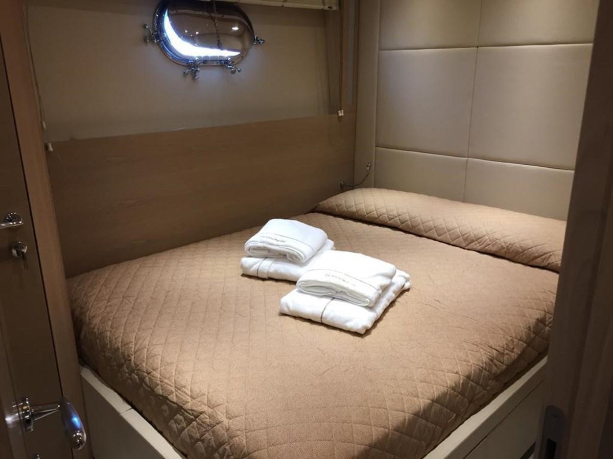 a bed with a white sheet aboard PATHOS Yacht for Sale