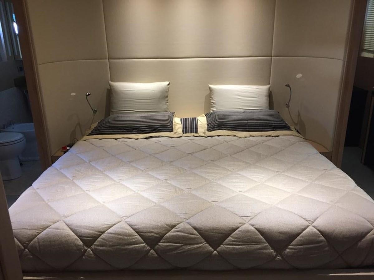 a bed with a white and black comforter aboard PATHOS Yacht for Sale